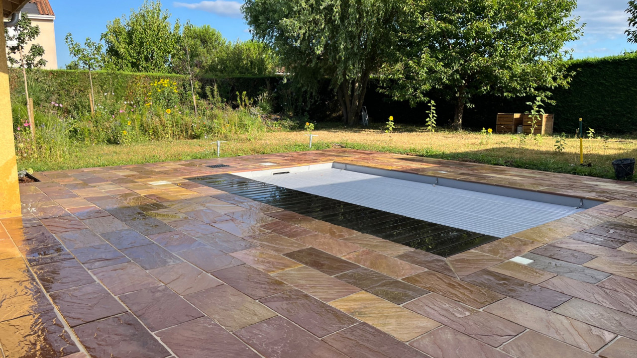 Terrasse minérale et margelle autour d'une piscine à Belleville-en-Beaujolais