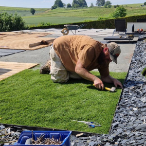 Création d'un jardin avec gazon et terrasse bois autour d'une piscine pour une maison moderne dans le Maconnais